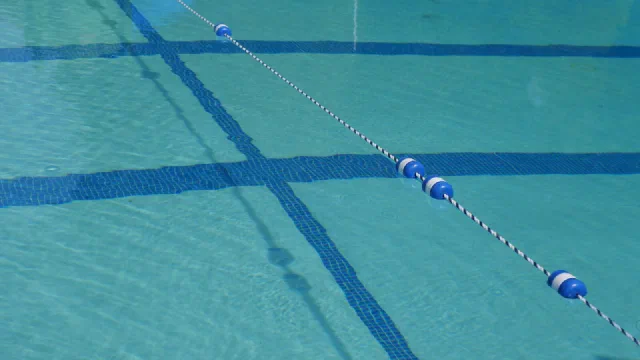 Lane ropes dividing the still water of a swimming pool