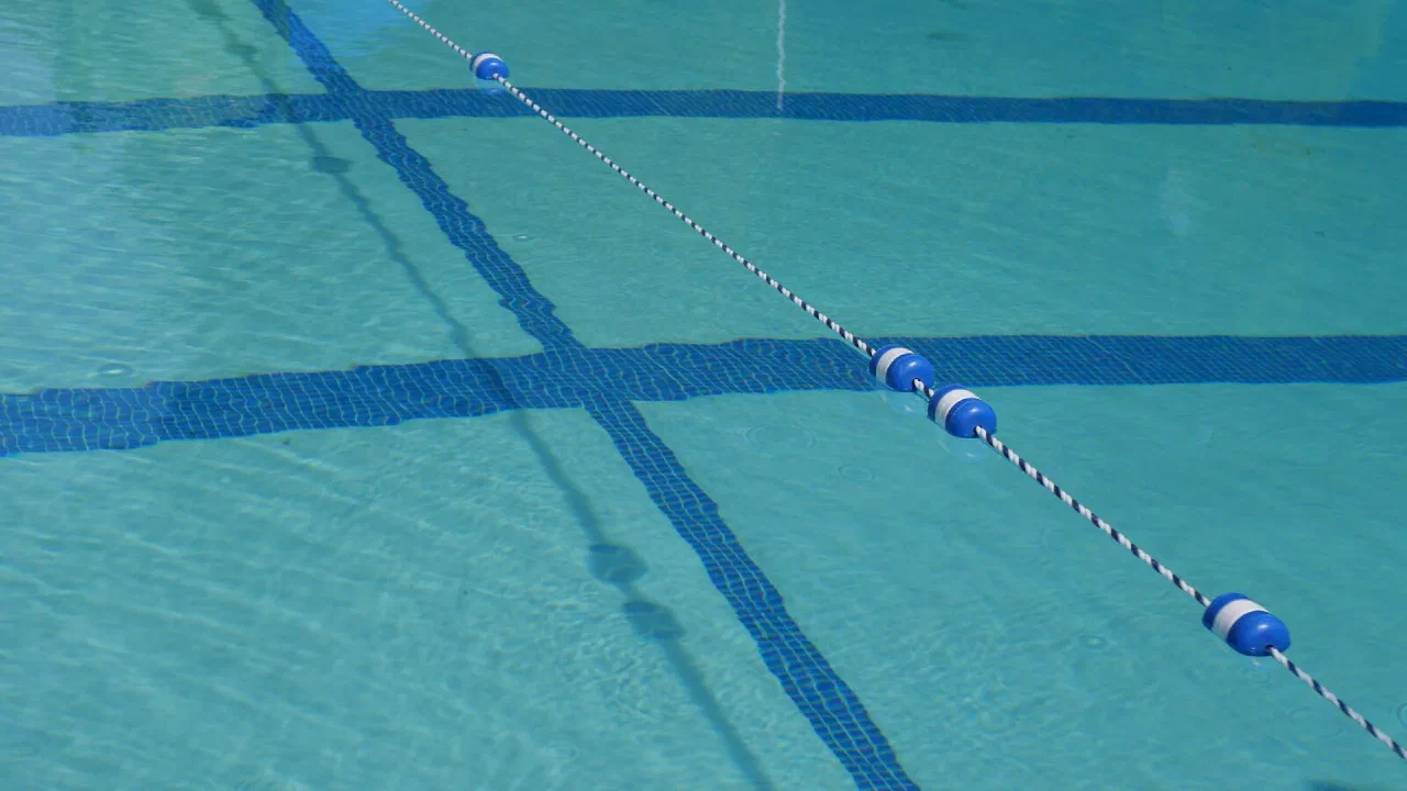 Lane ropes dividing the still water of a swimming pool