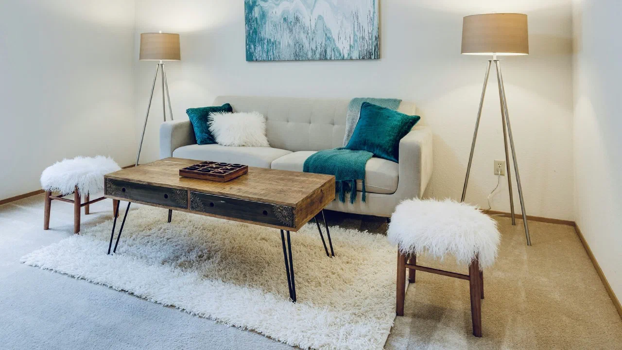 An empty living room with pale walls and clear floor space