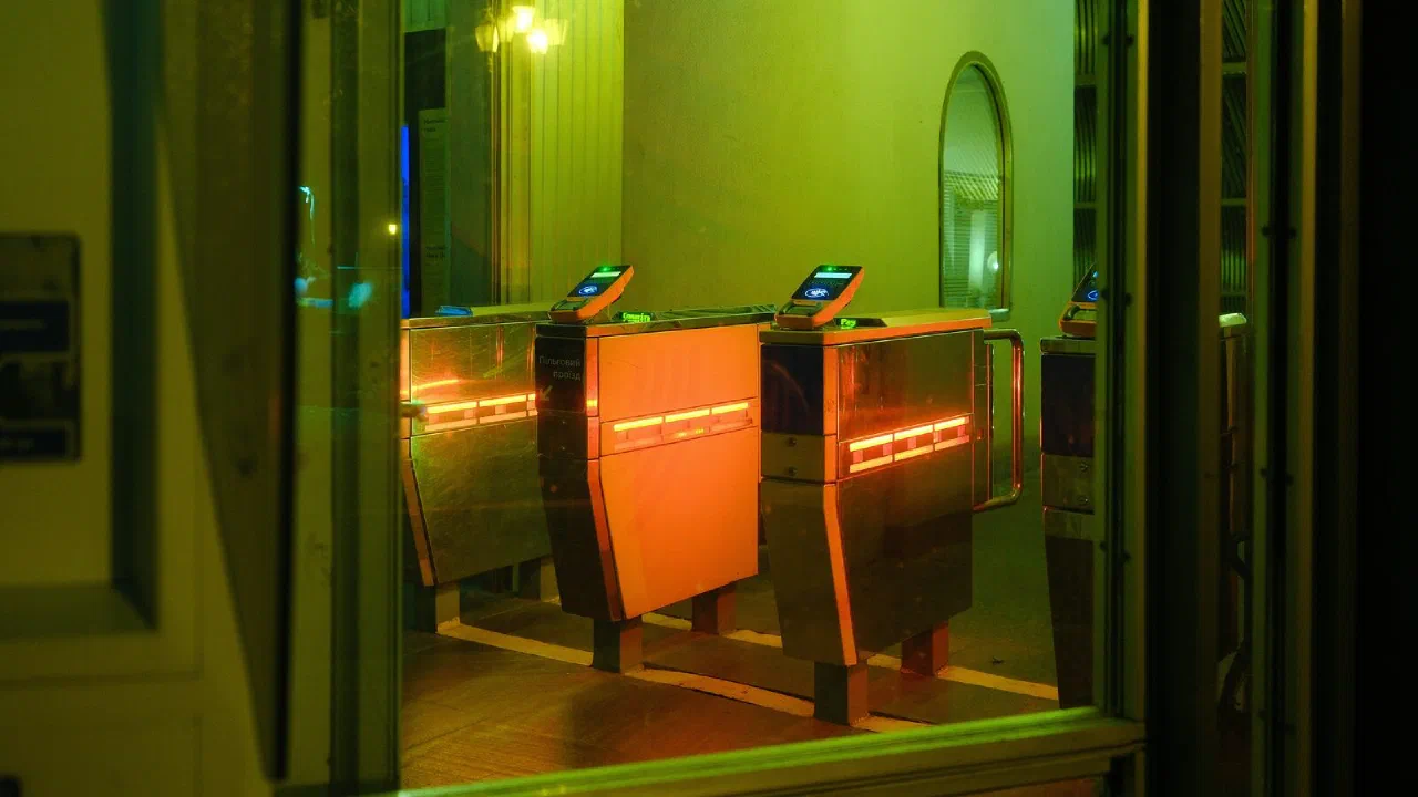 Entrance turnstiles lit with orange and green indicator lights