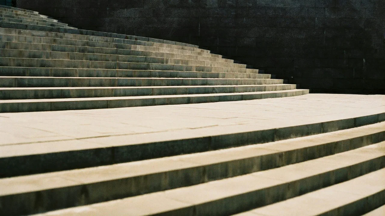 An empty grey concrete staircase in daylight